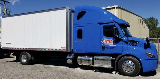 Blue JMSA straight truck with white box trailer